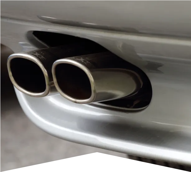 Muffler Repair in Clive, IA At Westside Auto Pros. Close-up of a car’s dual chrome exhaust pipes protruding from the rear bumper, with reflections visible on the shiny metal surface.