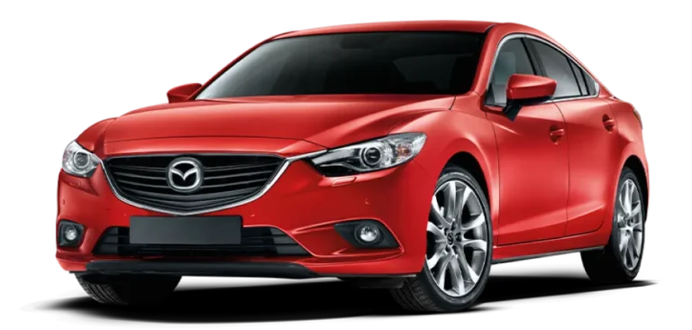 A red Mazda sedan is shown from a front-side angle, featuring a sleek design, prominent grille with the Mazda logo, sharp headlights, and silver alloy wheels.