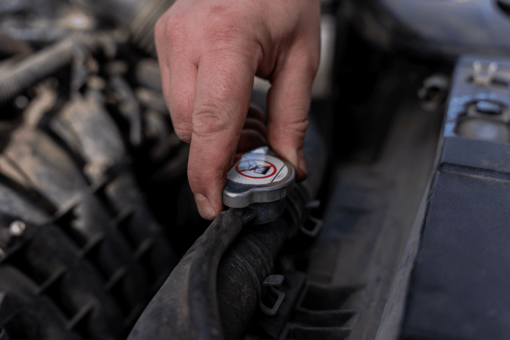 Radiator and Cooling System Service in Clive, IA by Westside Auto Pros, close up of mechanic inspecting a radiator's cap